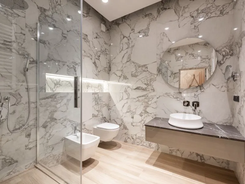 Modern bathroom finished in marble tile with a walk-in shower